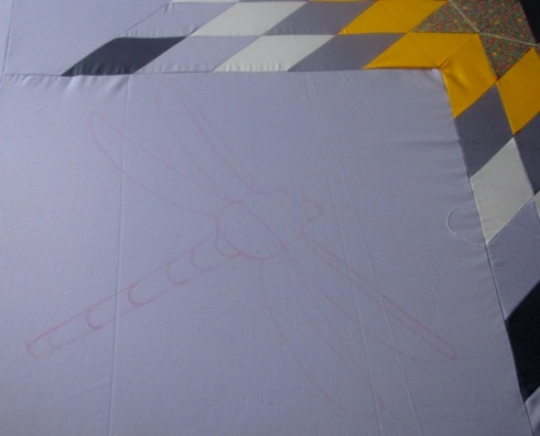 Outline where dragon fly was to be sewn on the Lakota star quilt.
